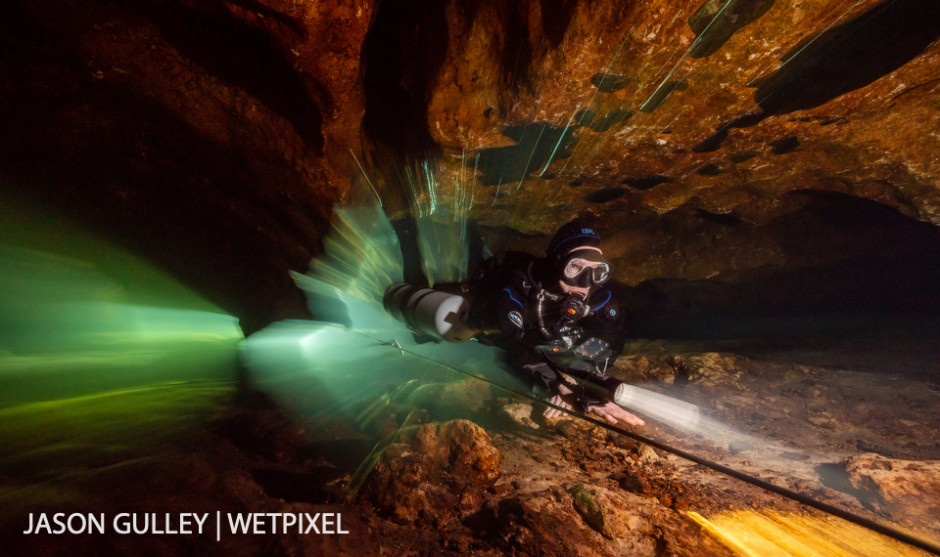 Hydrogeologist Dr. Patricia Spellman rides the flow out of a cave. Dr. Spellman uses observations from inside the aquifer to inform her research on how groundwater extraction impacts Florida’s springs.