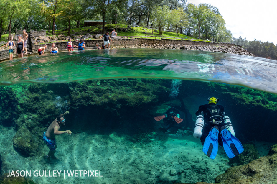 Cave divers enter the cave extending from Little River Spring, near Branford, Florida. Florida's springs are popular spots for swimmers as well as cave divers, especially in summer.