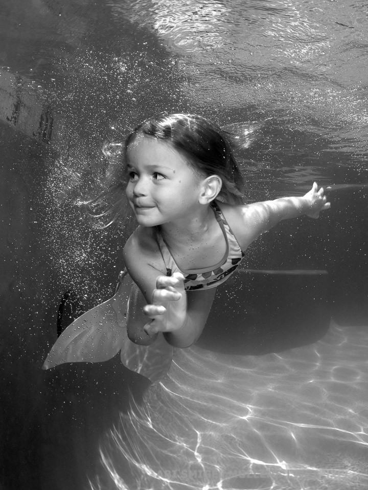 A cute underwater mermaid in black and white.